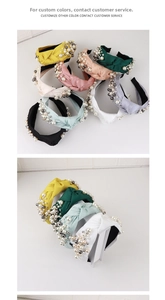 Detail of multi-color knotted headbands decorated with faux pearls and metallic beads