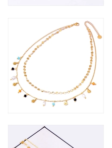 Detail of 18k gold double-layer necklace with stars, colorful beads and pearls