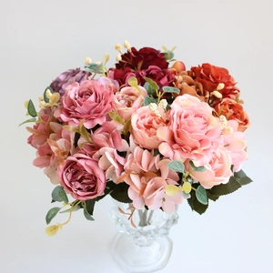 Close-up of silk rose and hydrangea bouquet in glass vase with realistic textures