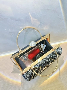 Interior view of black rhinestone evening clutch showing storage for phone and cosmetics