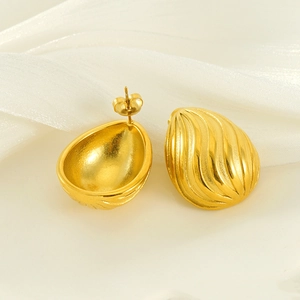 Ribbed gold droplet earrings in 18k gold plated stainless steel with a sleek silk backdrop
