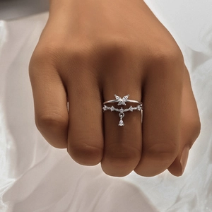 Close-up of S925 silver double-layered ring featuring a diamond butterfly and teardrop pendant