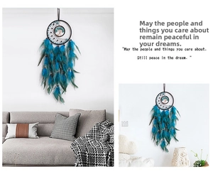 Detail of life tree dream catcher with blue gemstones and hanging dark blue feathers