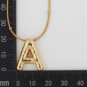 Detail shot of golden letter A necklace with bamboo texture, pendant size 22mm x 20mm