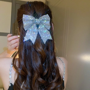Sparkling crystal butterfly bow hair clip showing detailed silver rhinestones on hair