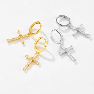 Macro detail of S925 silver cross pendant earrings with micro-set cubic zirconia stones