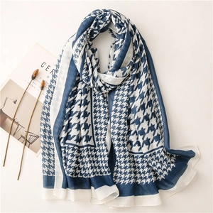 Close-up of blue and white houndstooth scarf with soft texture and elegant drape