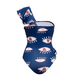 Detail of ruffle shoulder strap on navy blue one-piece swimsuit with pink evil eye print