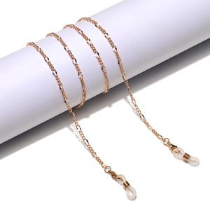Minimalist golden metal glasses chain with silicone loops shown on a white display stand