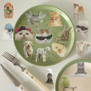 Close-up of waterproof cartoon animal stickers featuring funny cat and dog memes on a table