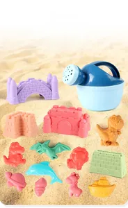 Detailed close-up of 13-piece colorful plastic beach toys including sand molds on real sand