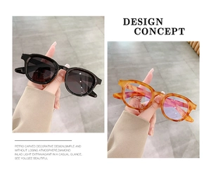Close-up of retro black and tortoiseshell round sunglasses with detailed carving