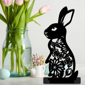 Detailed close-up of a black hollow rabbit silhouette decoration with Easter egg accents