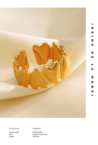 Macro shot of gold-plated heart-shaped open ring on premium silk background detail
