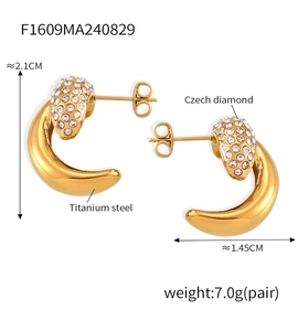 Detail showing 21mm gold crescent moon earrings with inlaid pavé crystals on titanium steel