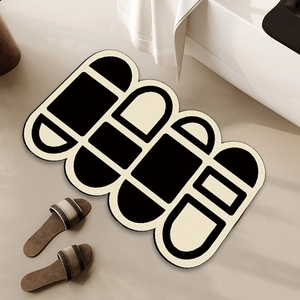 Absorbent irregular geometric bath mat in black and cream for bathroom slip prevention