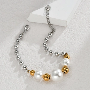Minimalist stainless steel necklace featuring silver beads and white pearls on white stone