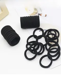 Detail of seamless black high-elasticity hair ties on a stand with minimalist decor