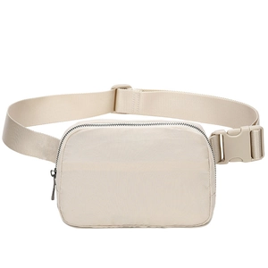 Front view of beige nylon crossbody waist bag with adjustable strap and plastic buckle
