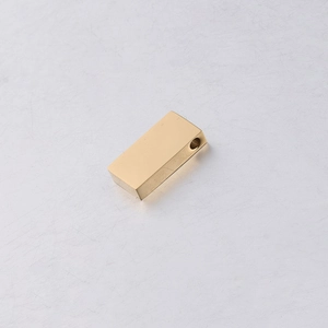 Macro shot of a polished golden stainless steel rectangular bead with 1.8mm hole for DIY jewelry