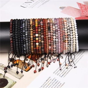 Detailed display of 4mm adjustable natural stone bead bracelets on a black display stand