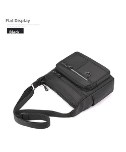 Detail of multi-pocket black nylon crossbody bag with durable zippers and D-ring