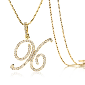 Gros plan d'un pendentif lettre H dorée en écriture cursive serti de zircons brillants