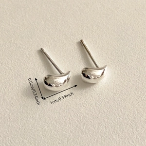 Macro shot showing dimensions of hollow waterdrop silver studs with mirror finish