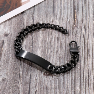 Detail of matte black stainless steel Cuban link bracelet with engravable blank bar plate