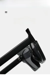 Macro view of polished black cat-eye sunglasses hinge and textured temple detail