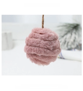 Detailed view of pink faux fur Christmas pompom ornament with natural jute rope hanger