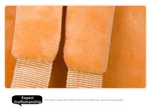 Detail of soft orange plush shoulder strap with reinforced stitching on toddler backpack