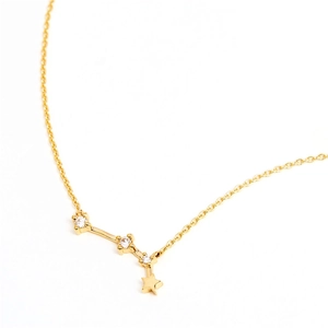 Close-up of a gold S925 sterling silver zodiac necklace with star pendant and crystals