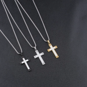 Three minimalist titanium steel cross necklaces in black, silver, and gold finishes