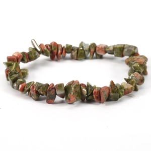 Detailed view of irregular Unakite natural stone chips on a clear elastic bracelet cord
