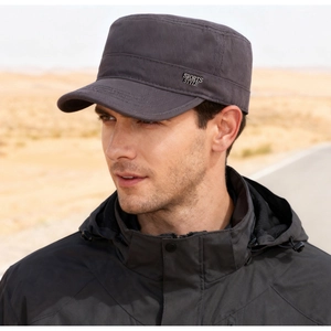 Detail of dark grey flat top cap with Sports Style metal badge on side profile
