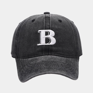 Close-up of white 3D embroidered letter B on a dark grey washed cotton baseball cap