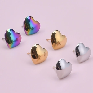 Detailed view of heart-shaped stainless steel earrings in iridescent gold and silver colors