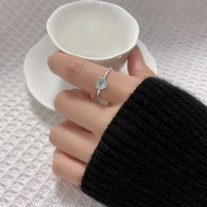 Iridescent aurora moonstone heart ring in silver finish worn on the finger