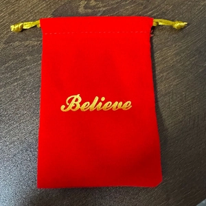Christmas red velvet Believe drawstring bag with golden lettering for holiday decor