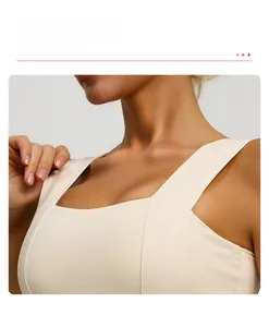 Detail view of beige sports bra featuring wide double straps and seamless elastic fabric