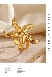 Detailed macro shot of a gold starfish open ring with realistic textured finish