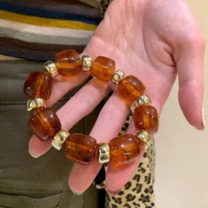 Minimalist geometric amber acrylic beaded bracelet with golden spacers for women