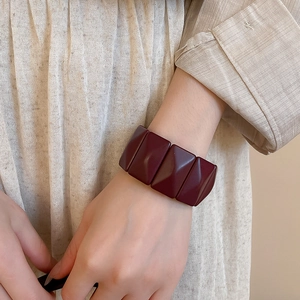 Close-up of deep red vintage resin geometric bracelet on a model wrist for fashion