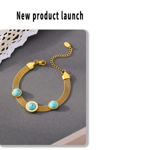 Detailed view of wide mesh gold bracelet featuring three turquoise round stones and lobster clasp