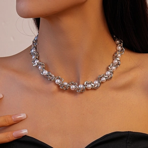 Close-up of metallic chain and pearl woven choker necklace on a female model