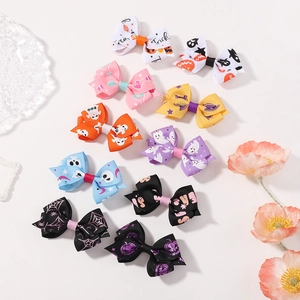 Set of 10 Halloween fabric bow hair clips with ghost and pumpkin patterns on white background