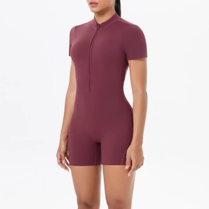 Detail of burgundy short sleeve fitness bodysuit showing zipper collar and yoga fabric