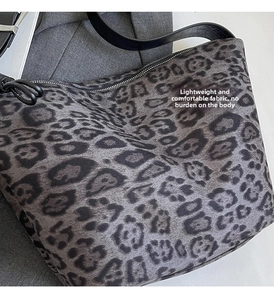 Close-up of leopard print tote bag fabric texture with soft faux fur finish and black strap