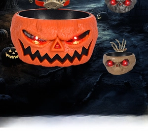 Close-up of Halloween animated candy bowl with glowing red eyes and moving skull hand
